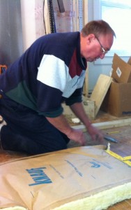 Steve measures insulation for the attic.