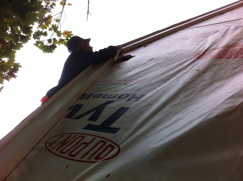 Jim on the roof peak installing J channel. I wish this picture had come out clearer... he was hanging out over the top of the roof!